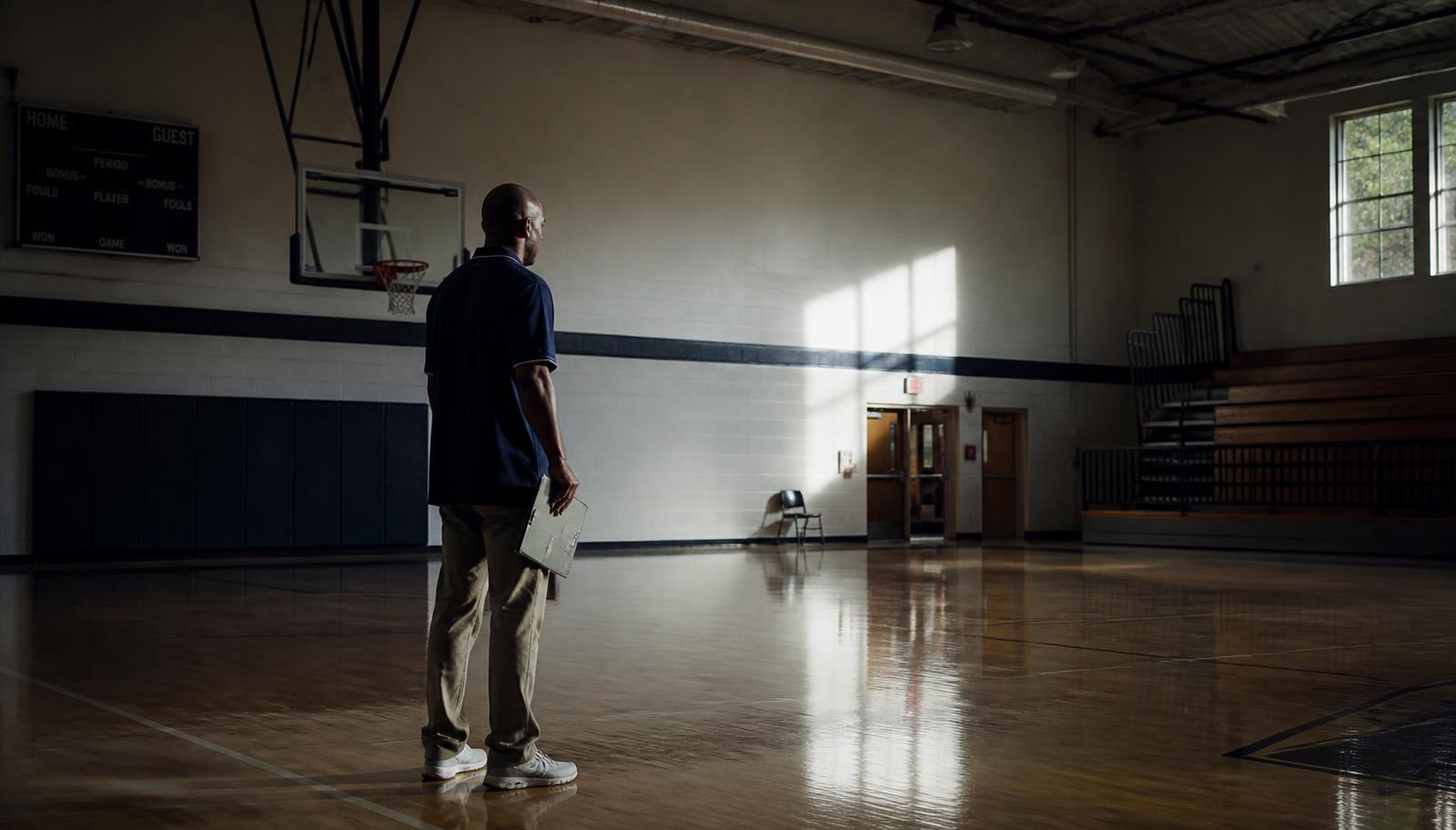 A coach alone in a gym after practice